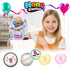 smiling child holding Craft for Kids Nano Creations party pack with glitter sensory bubble creations and colourful DIY mix ins for creative party fun Adventure Awaits