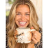 Smiling woman holding a cream ceramic cat mug shaped like a curled tabby — Adventure Awaits