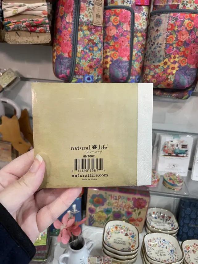 Back of It’s the Little Things happy notes booklet in colourful gift shop display — Adventure Awaits