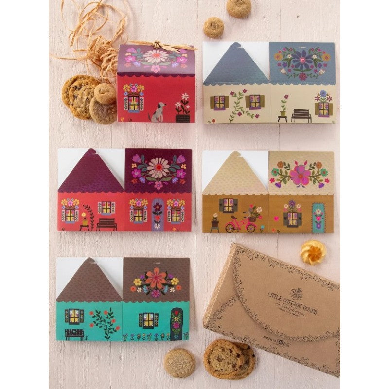 Flat lay of floral cottage cards and gift box with biscuits, creative stationery and unique gift set