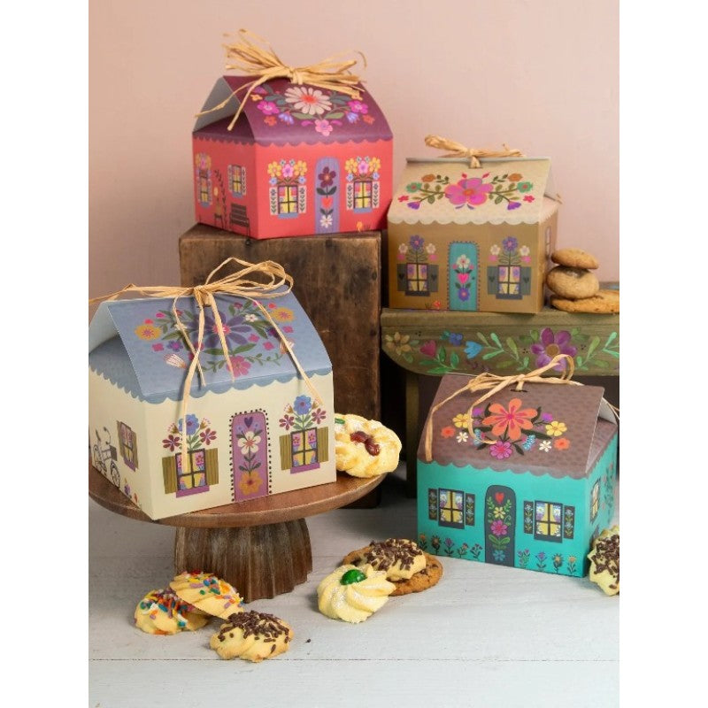 Floral cottage gift boxes with ribbon on display with biscuits, colourful unique gift packaging for hampers Adventure Awaits