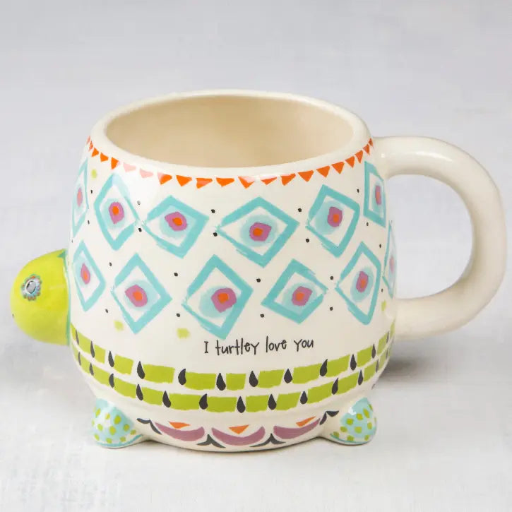 Whimsical turtle shaped ceramic mug with colourful geometric patterns and “I turtley love you” message