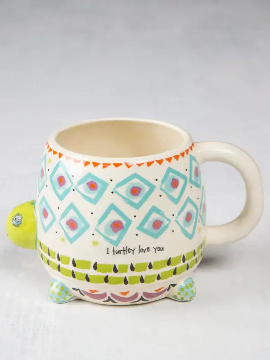 Turtle shaped ceramic mug with colourful geometric patterns and “I turtley love you” quote