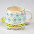 Whimsical turtle shaped ceramic mug with colourful geometric patterns and “I turtley love you” message