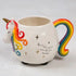 Unicorn shaped ceramic mug with rainbow mane and tail featuring “Don’t let anyone ever dull your sparkle” quote