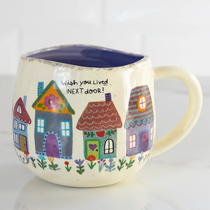 "Wish You Lived Next Door" ceramic mug with colourful house design and navy interior — Adventure Awaits