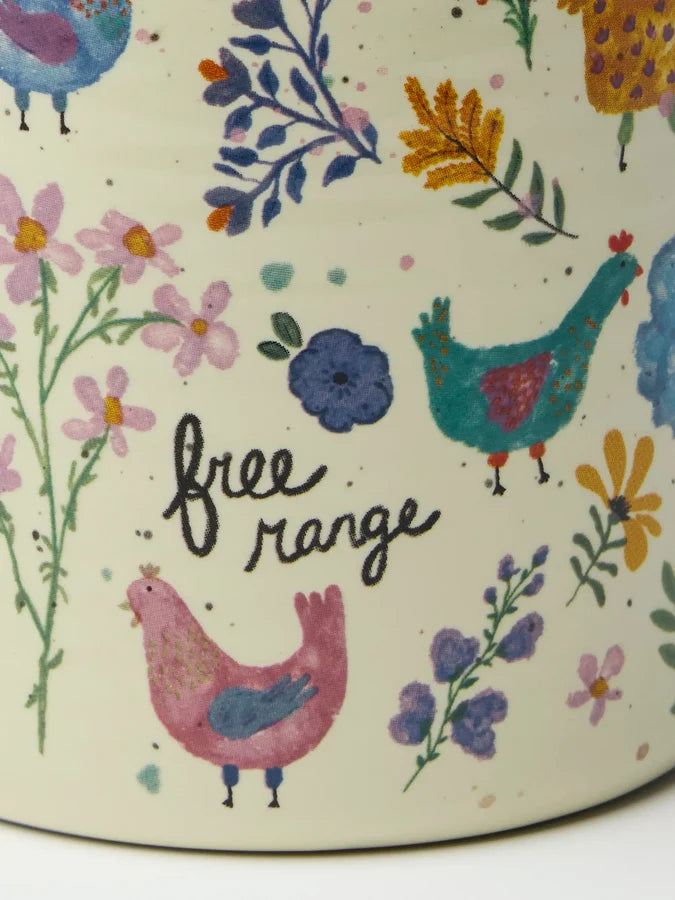 Close-up of Natural Life Free Range chicken mug with colourful hens, flowers and handwritten text — Adventure Awaits