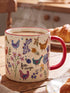 Natural Life Free Range chicken mug filled with a hot drink on a kitchen table — Adventure Awaits