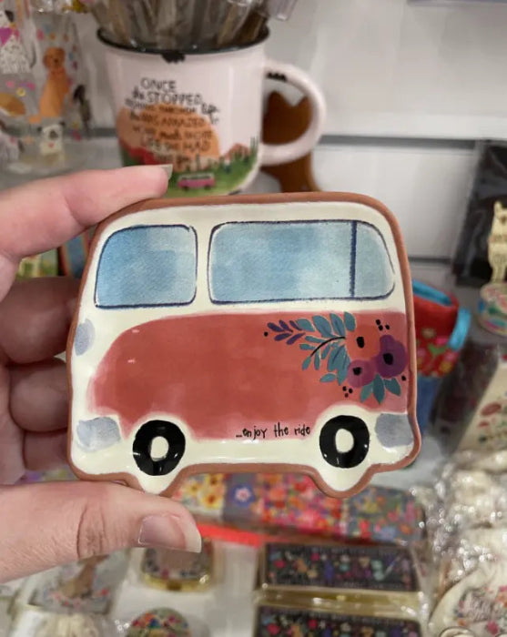 Hand holding Natural Life campervan trinket dish with floral detail and “enjoy the ride” message — Adventure Awaits