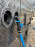 Navigator Tank Filler Buddy connected to a caravan water inlet with blue hose and airflow valve - Adventure Awaits