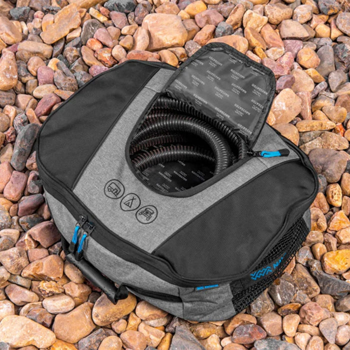 Navigator Sullage Buddy storage bag open on gravel showing coiled sullage hose and top accessory pocket — Adventure Awaits