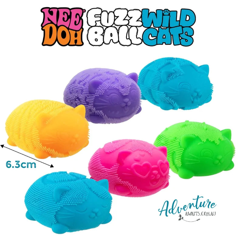 Six colorful cat-shaped ball toys with soft bristles, shown on a white background with the text 'NEE DOH FUZZWILD BALL CATS' at the top and a size marker '6.3cm' on one toy.