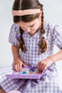 Girl playing with Oh Flossy kids makeup set, gentle pretend play beauty kit for dress ups and creative fun Adventure Awaits