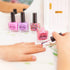 Child painting nails with Oh Flossy pink glitter polish at play table, fun non toxic kids nail polish for dress ups Adventure Awaits