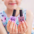 Child holding Oh Flossy kids nail polish bottles in pastel and glitter shades, non toxic dress up fun Adventure Awaits