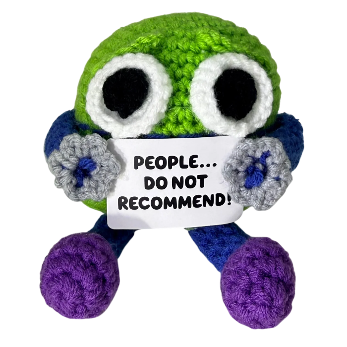 handmade crochet monster plush toy with oversized eyes holding a funny “People… Do Not Recommend!” sign