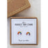 gold plated perfect tiny studs with multicoloured stones arranged in single row in shape of a rainbow in a earring box