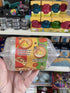 Hand holding Pizza Slime DIY pack showing decorate and finish steps on toy shop shelf — Adventure Awaits