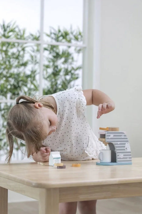 Child playing with PolarB wooden coffee machine play set at table — Adventure Awaits