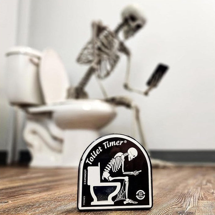 Skeletal figure sitting on a toilet with a 'Toilet Timer' sign in the foreground.