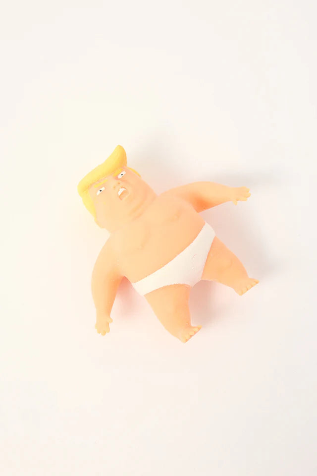 Political caricature stress toy in white briefs lying on plain background — Adventure Awaits