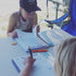 Young kids having fun filling in the kids travel journal 