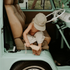 toddler using sande kids sand brush to clean sand off feet in door of vehicle