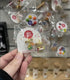 Saturday Lollipop lolly jar earrings held in store packaging — Adventure Awaits