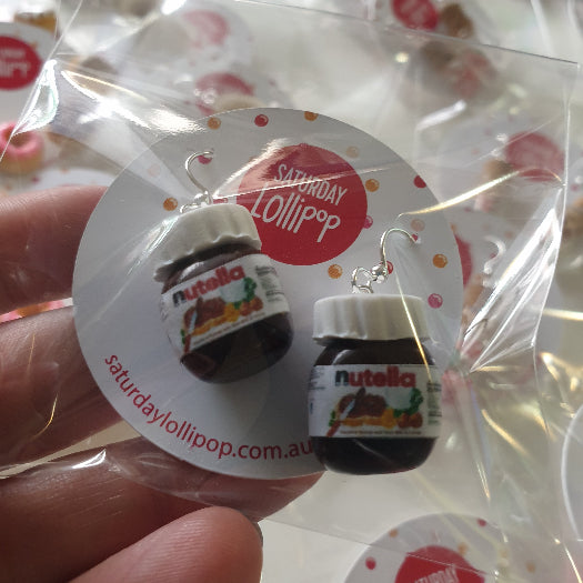 Mini Nutella jar drop earrings on a Saturday Lollipop card in clear packaging, Adventure Awaits