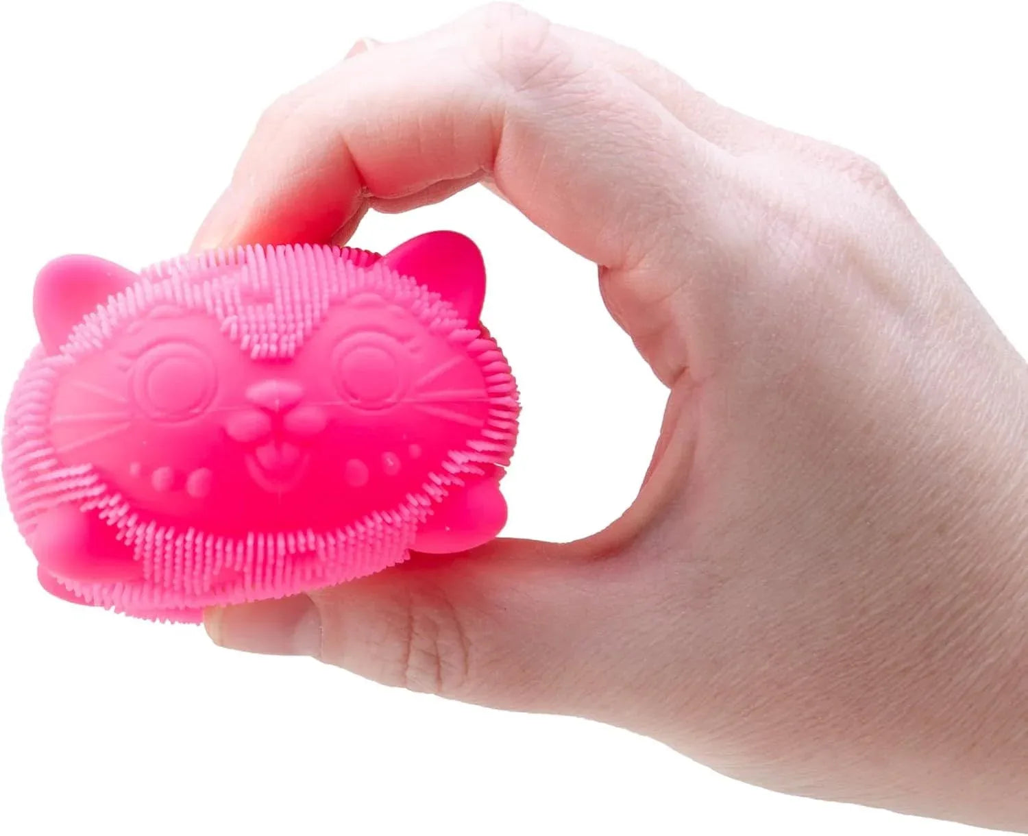 Hand holding a pink silicone scrubber shaped like a cat on a white background