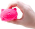Hand holding a pink silicone scrubber shaped like a cat on a white background