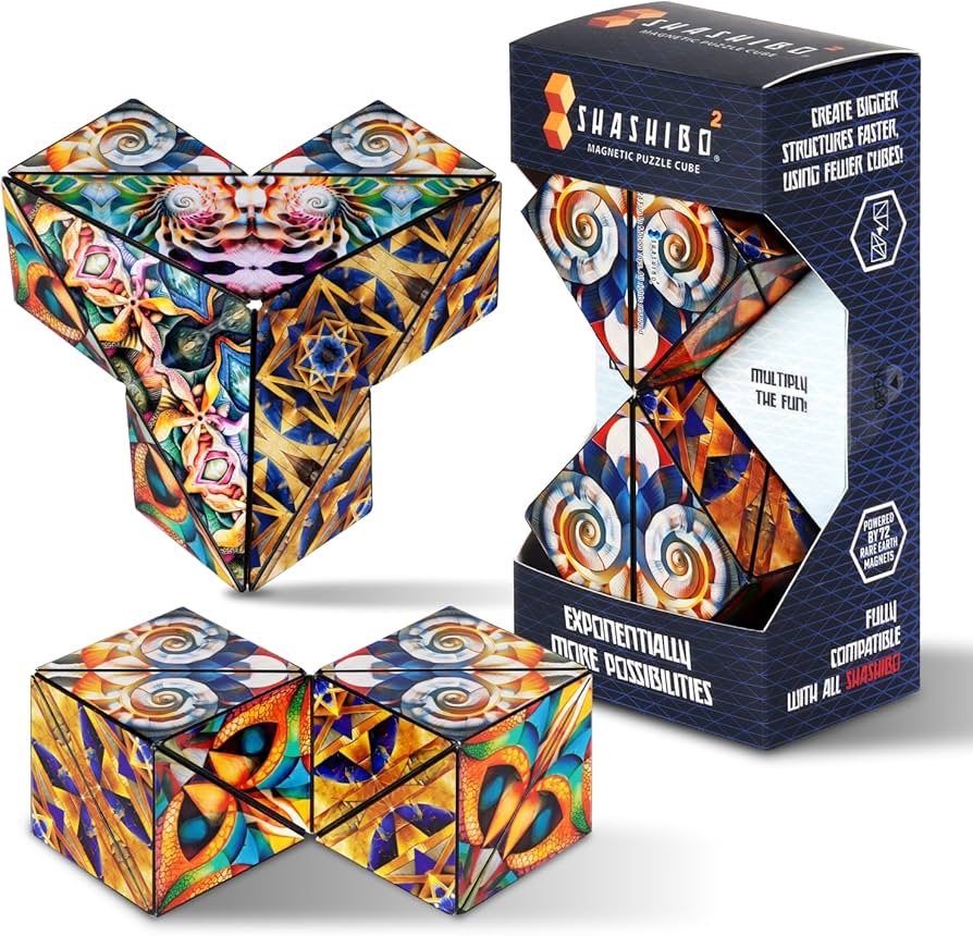 Shashibo magnetic puzzle cube with vibrant abstract kaleidoscope artwork transforming into geometric shapes beside matching retail packaging Adventure Awaits