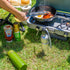 ShooAway rechargeable fly repeller on bottle beside camp stove cooking breakfast — Adventure Awaits