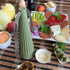 Green ribbed portable lantern on picnic table beside cheese board and olives — Adventure Awaits