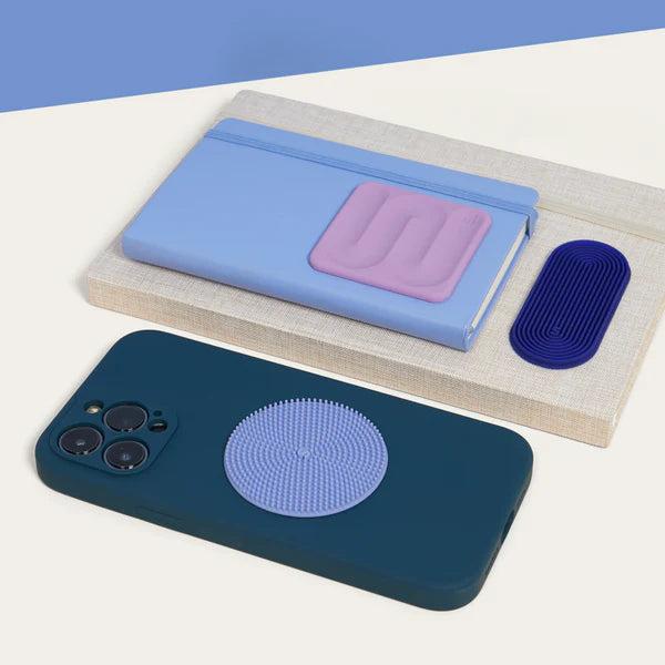 Phone case with speks slabs fidget silicone stickers -  blue and purple design on a white surface