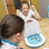 Kids laughing while playing Sink the Floater poop-themed tabletop game at a table — Adventure Awaits