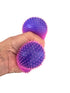 Hand squeezing purple and pink spiky sensory stress balls with soft stretchy tactile texture