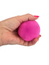 Hand holding a bright pink textured sensory stress ball with soft flexible spiky surface