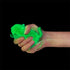 Hand squeezing green glow in the dark cat squishy toy against black background — Adventure Awaits