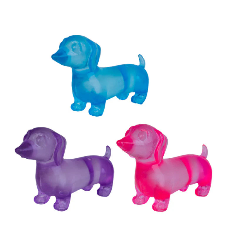 Blue, purple and pink translucent dachshund squishy toys on white background — Adventure Awaits