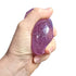 Hand squeezing purple diamond squishy toy with translucent glitter finish — Adventure Awaits