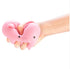 Hand squeezing a soft pink pig shaped squishy sensory toy with stretchy stress relief texture