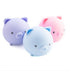 Trio of pastel pig shaped squishy sensory toys in purple, blue and pink with cute faces