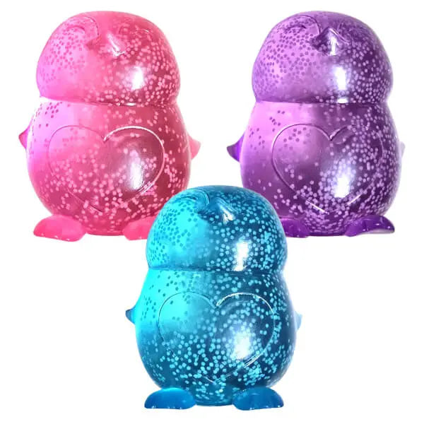 Smooshos glitter glow in the dark penguin sensory toys in pink, purple and blue with sparkling liquid-filled bodies — Adventure Awaits