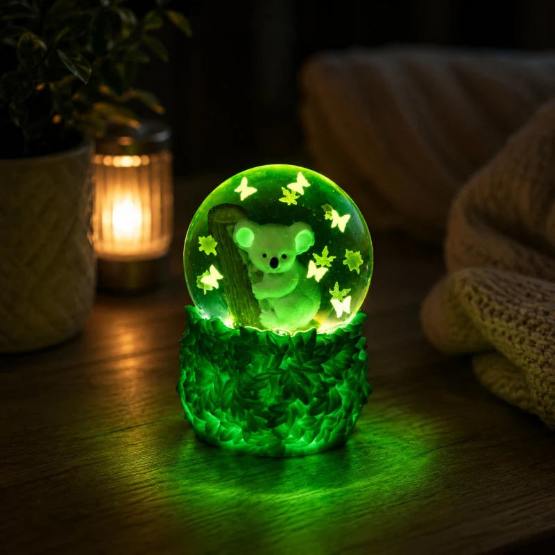 Smooshos Glow in the Dark Snow Globe  koala squishy toy glowing in the dark on bedside table — Adventure Awaits