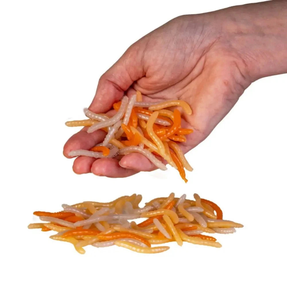 Hand holding Smooshos stretchy worms sensory toy in orange and cream colours — Adventure Awaits