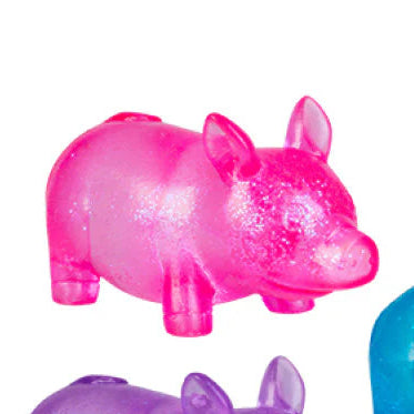 Three colorful rhino figurines in pink, purple, and blue on a white background