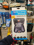 Solar Camp Shower packaging held in a store aisle with various items in the background
