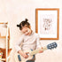 Child playing blue wooden toy guitar in nursery with small steps wall print — Adventure Awaits