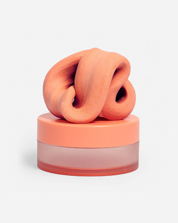 Orange SPEKS Blur calming focus putty twisted on its matching storage tub — Adventure Awaits